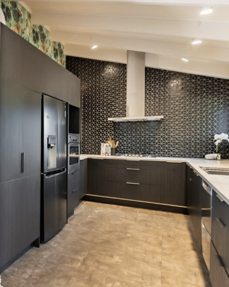 Dark contemporary kitchen with black cabinetry, geometric mosaic tile splashback and integrated lighting — The Midnight Kitchen by Zander Edward